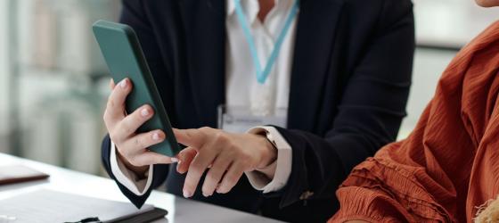  A women showing online registration on mobile phone
