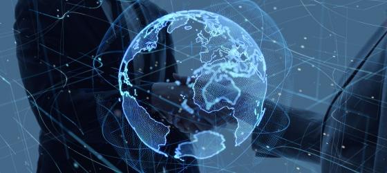 global network concept: two men shaking hands under a graphic image of the world